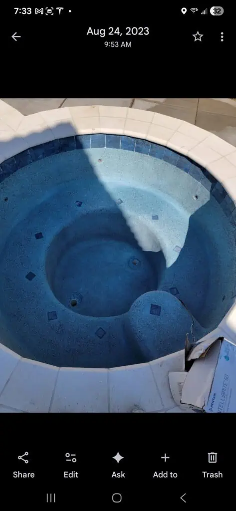 Custom blue pool with smooth plaster finish, perfect for backyard oasis.