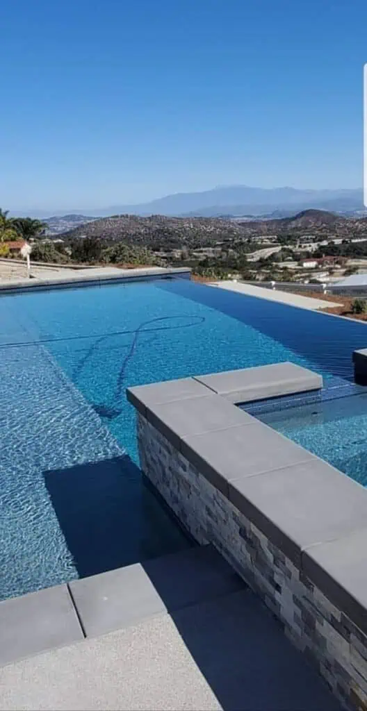 Modern backyard pool with sleek design and mountain backdrop.