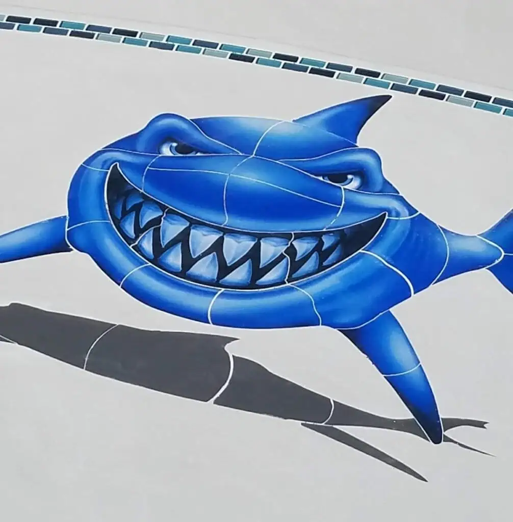 Playful blue shark cartoon design for pool decor and plastering projects.