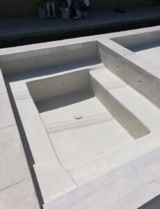Custom pool with smooth white plaster finish, professional pool plastering services.